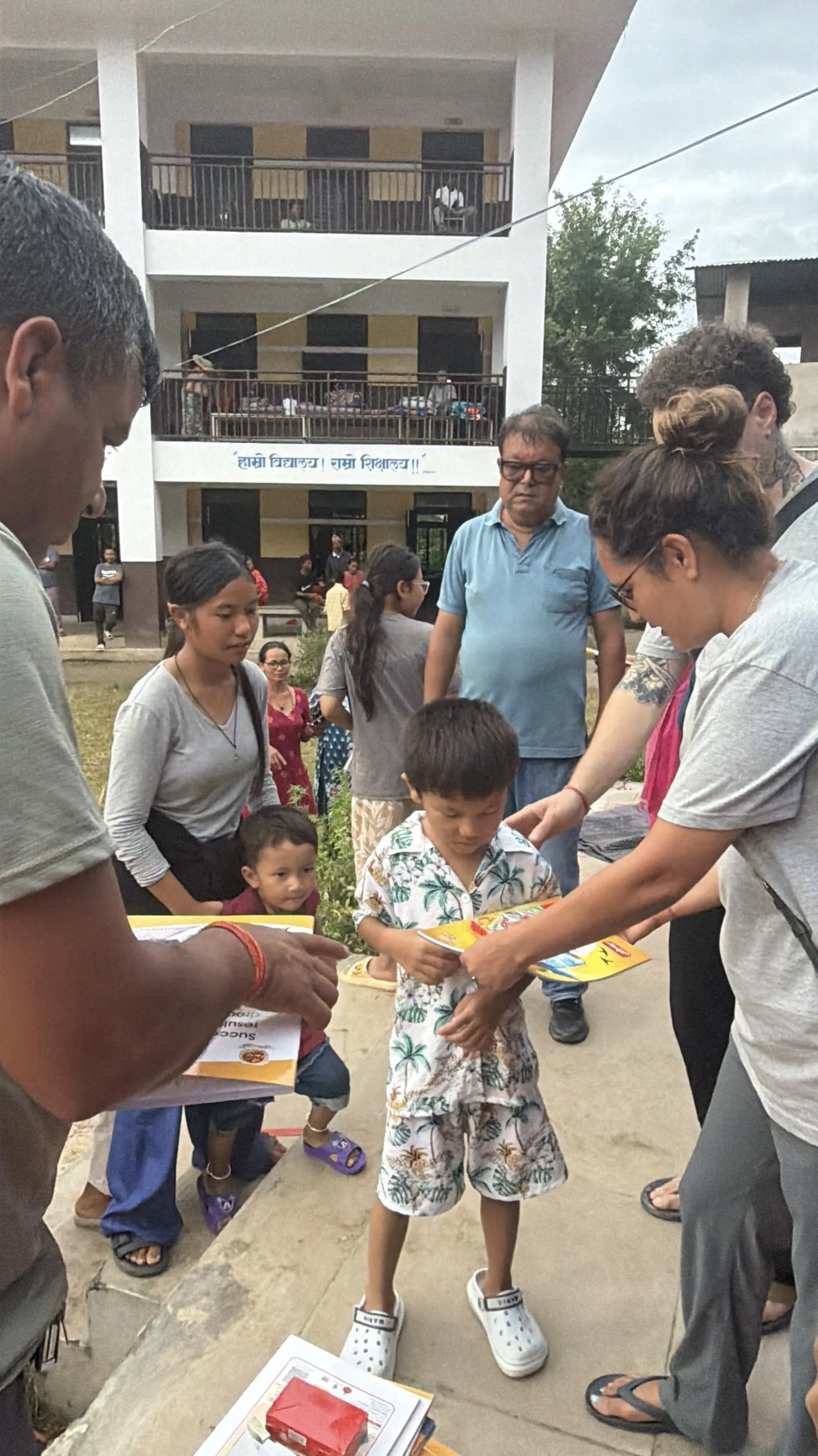 Handing out books and supplies to children