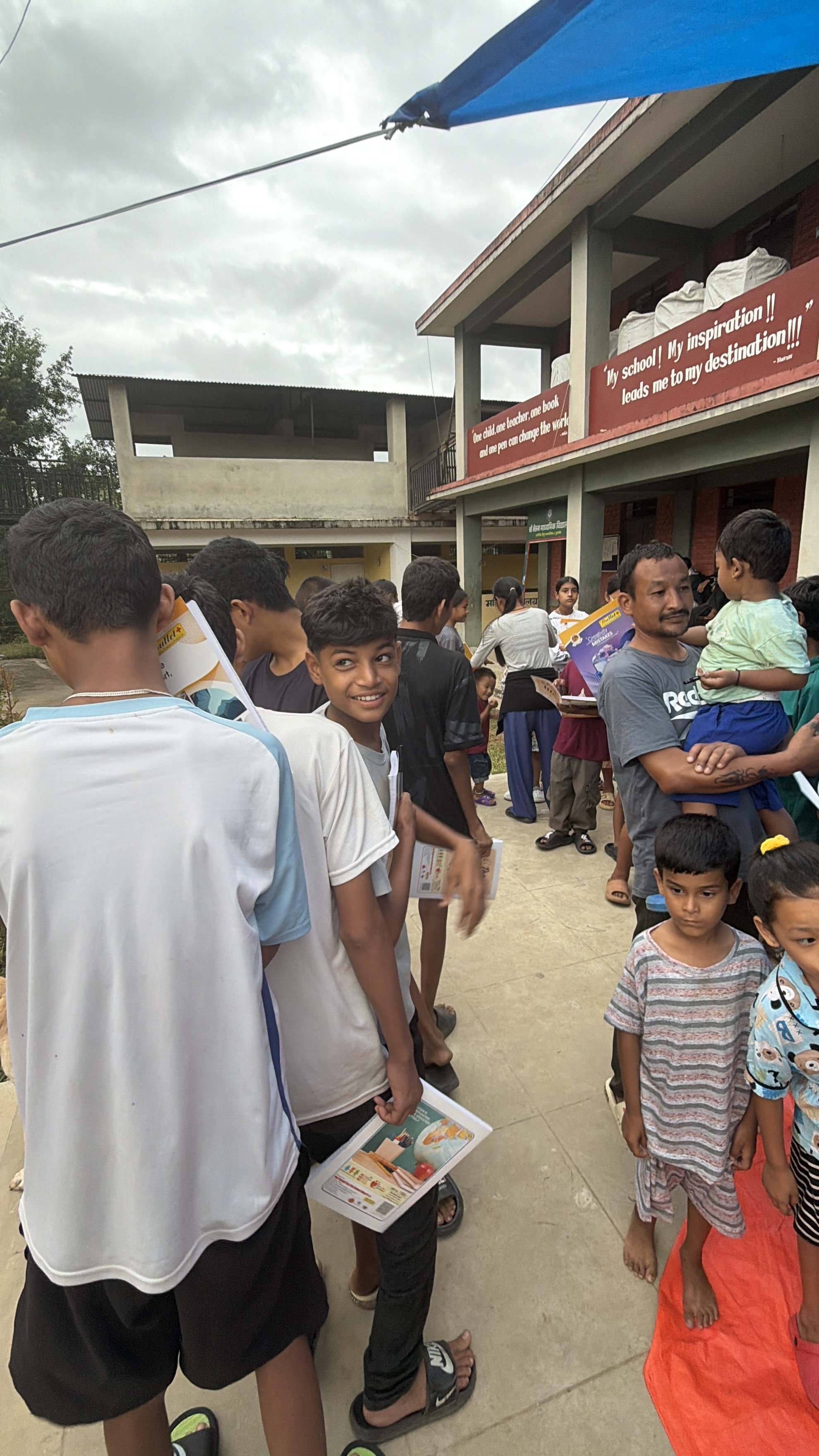 Children receiving books and supplies