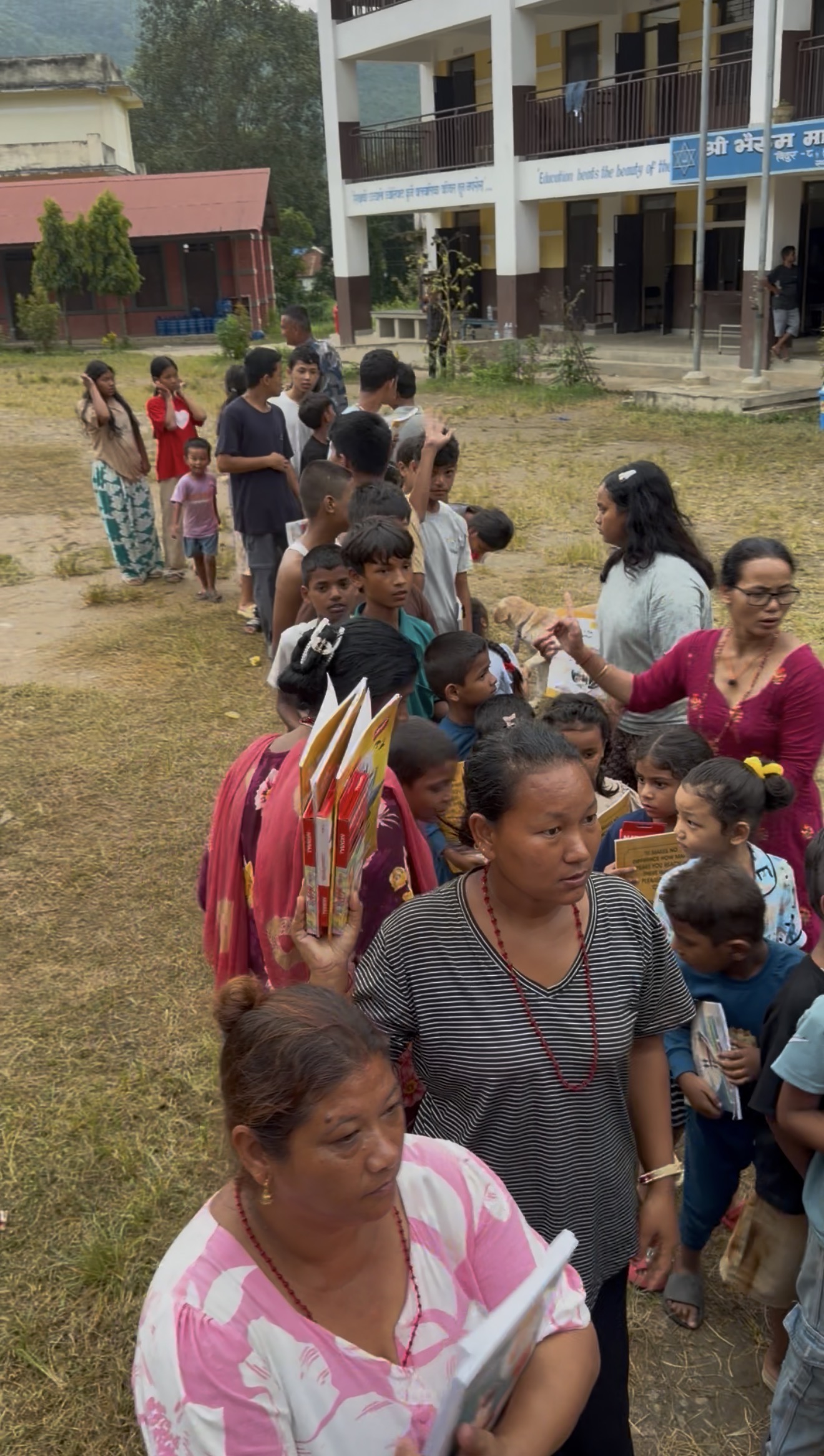Children lined up with new workbooks