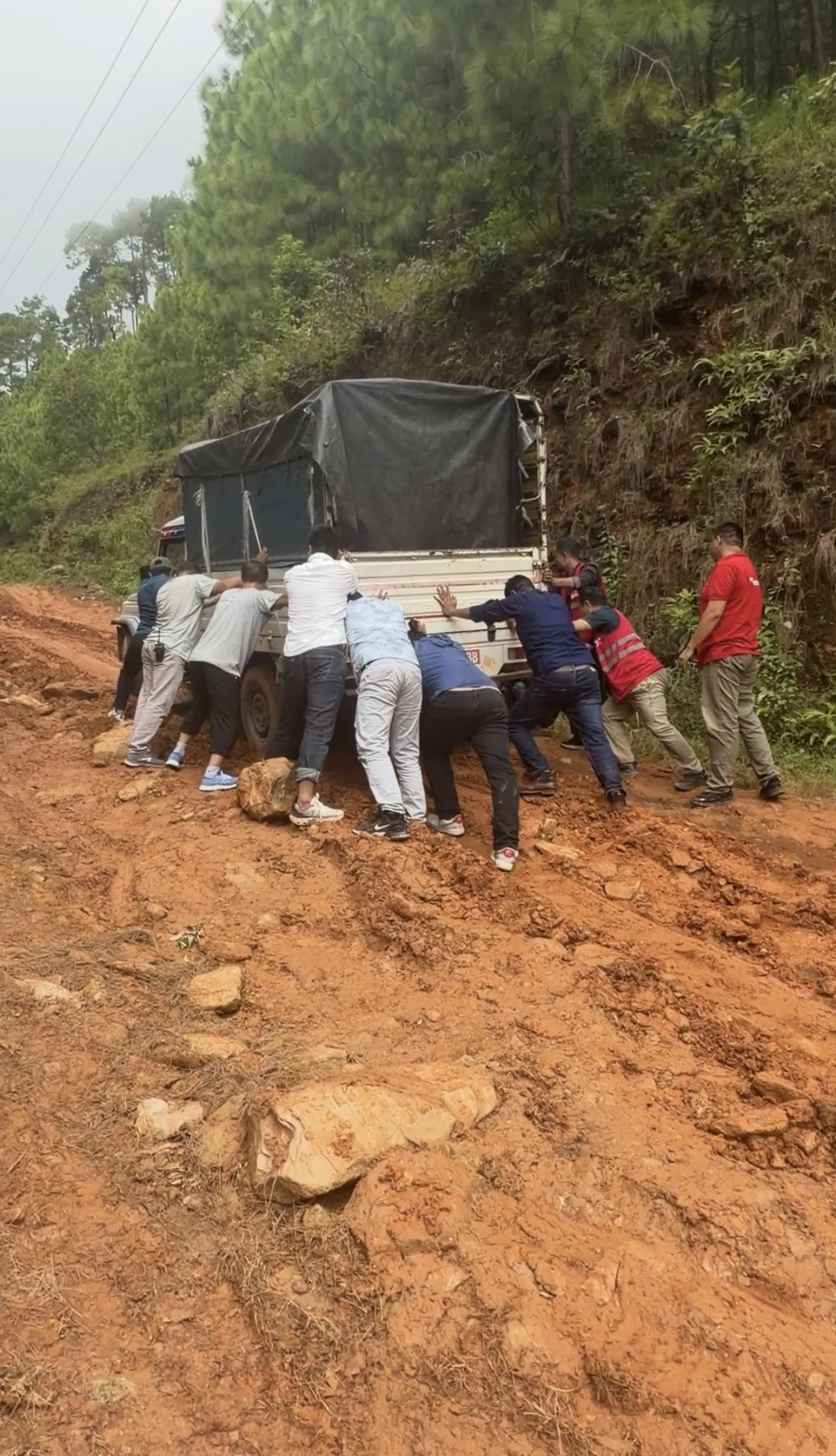 Pushing a supply truck through the mud